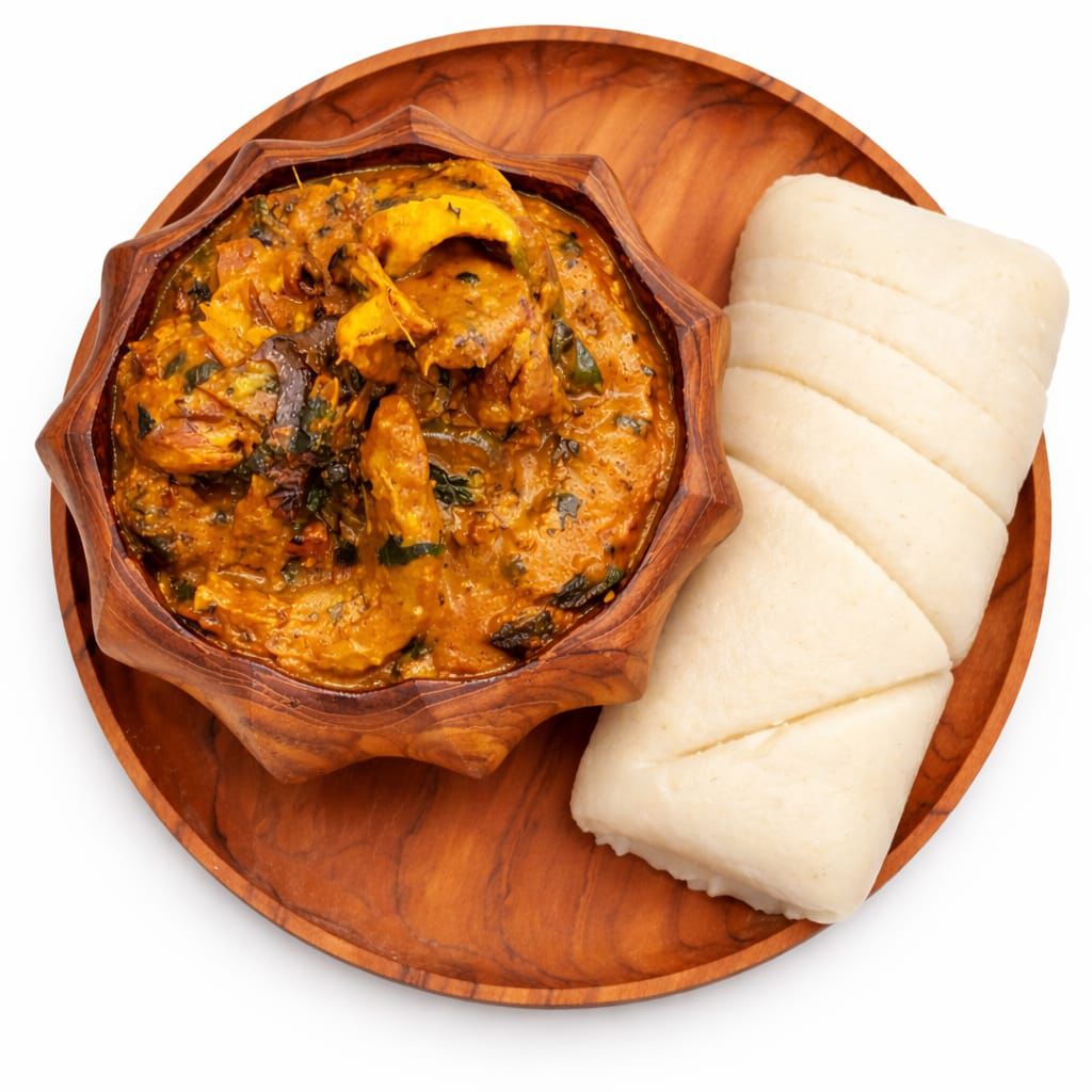 Nigerian soup and swallow served on a wooden plate
